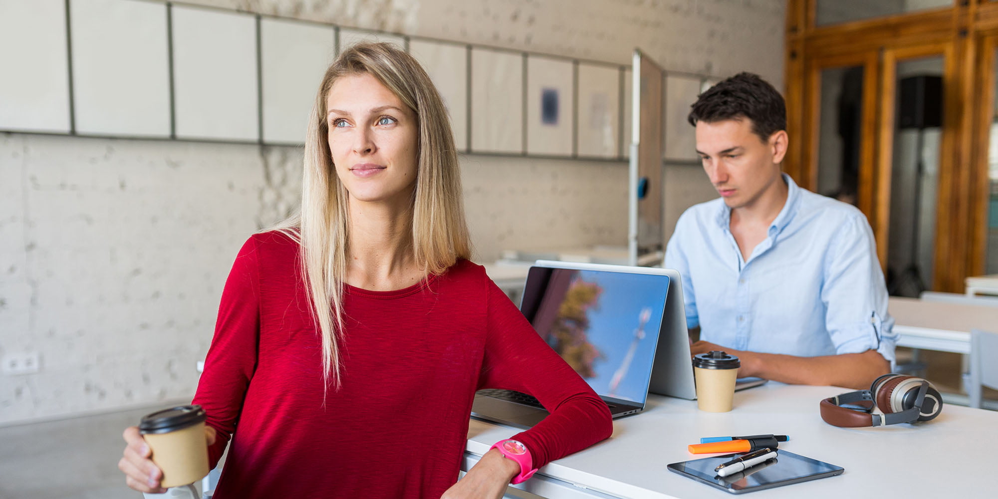 young-man-and-woman-working-on-laptop-in-open-spac-KKA2A3H.jpg